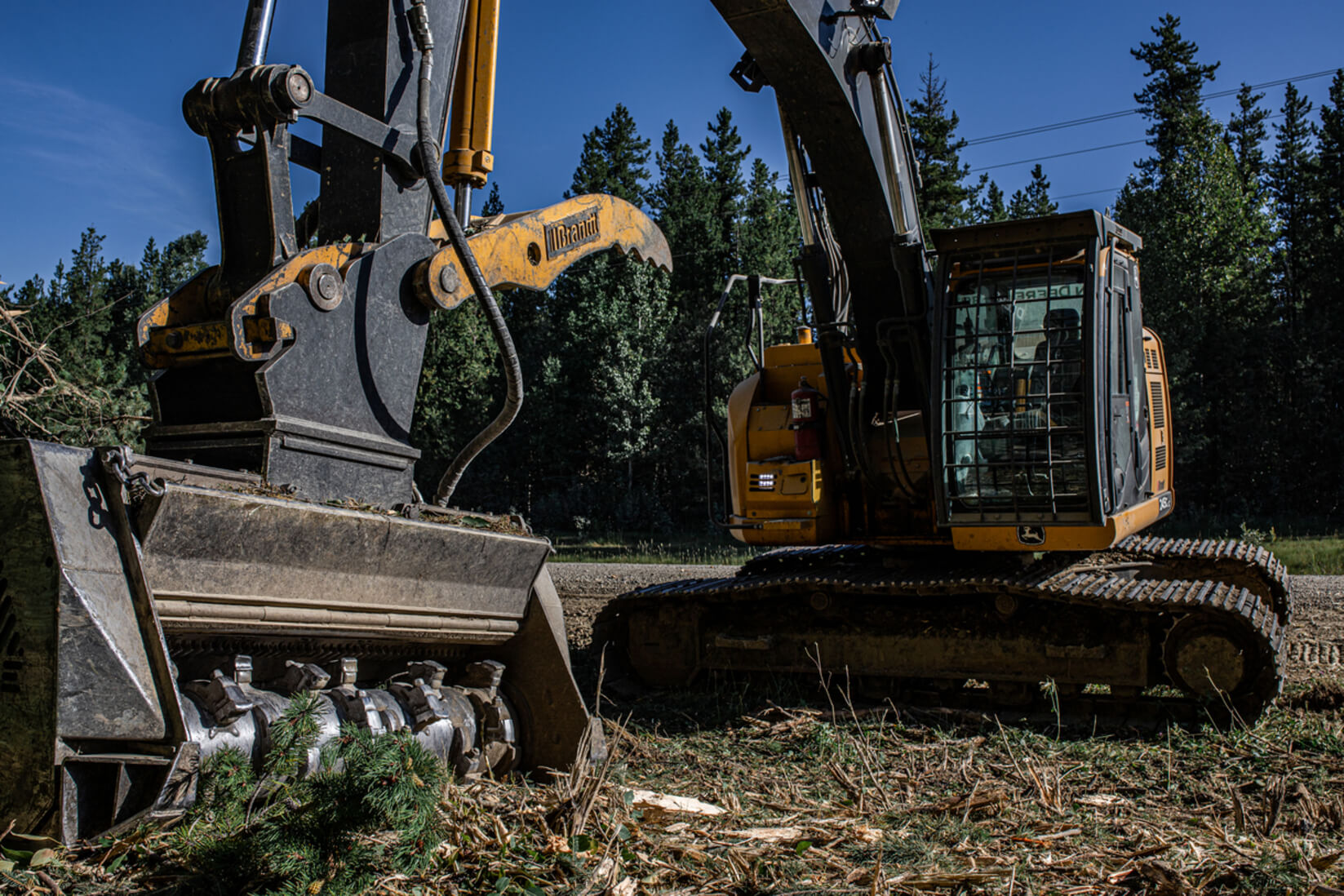 Noble Enterpises operates an excavator with a mulching head for clearing road and pipeline right of ways